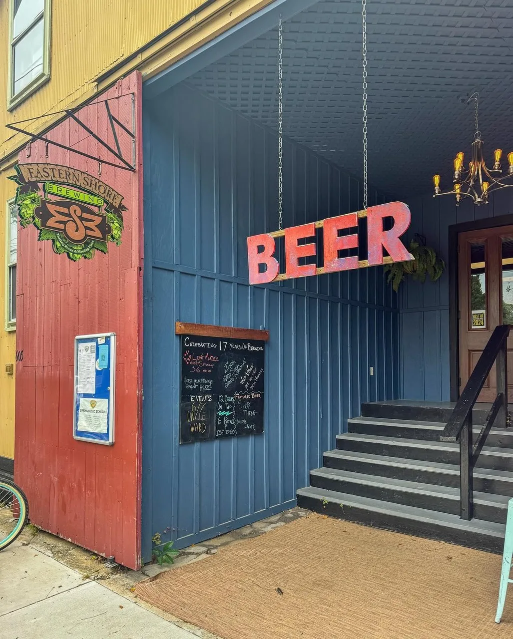 Exterior of Eastern Shore Brewing with Beer sign hanging.
