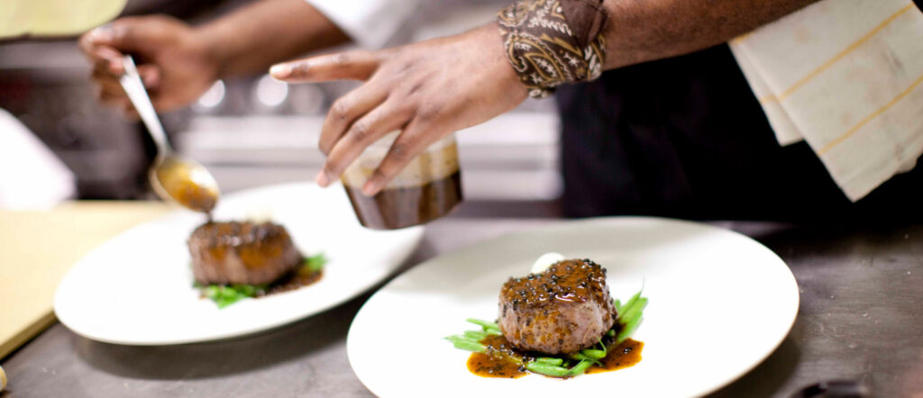 Easton chef plating food in a restaurant.