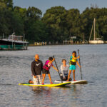 Family paddleboarding on the river.