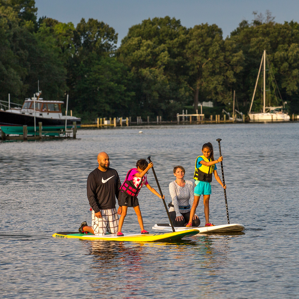 Family paddleboarding on the river.