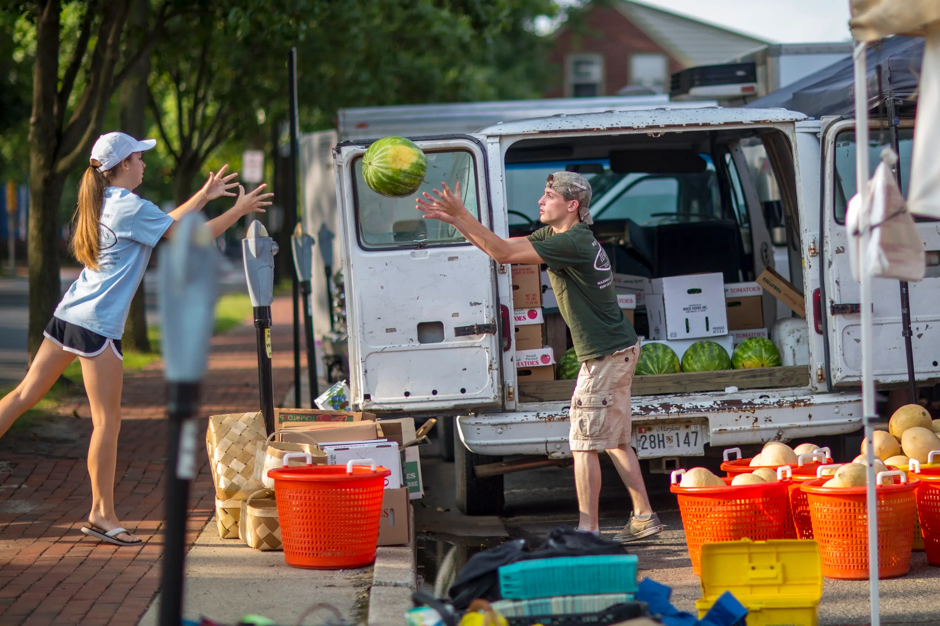 Unloading produce from a van at the Farmers Market.
